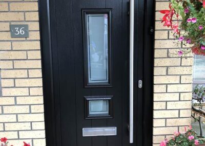 Esk Black double composite door with 1200 long bar handle and virtue glass