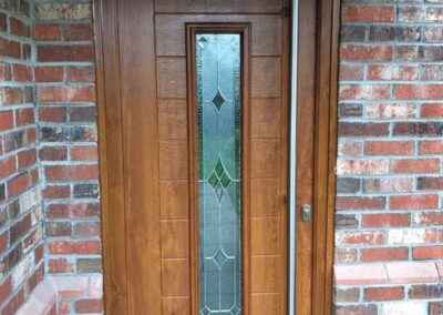 Oak Fuji Composite door with Riviera glass and an 1800 Long bar handle